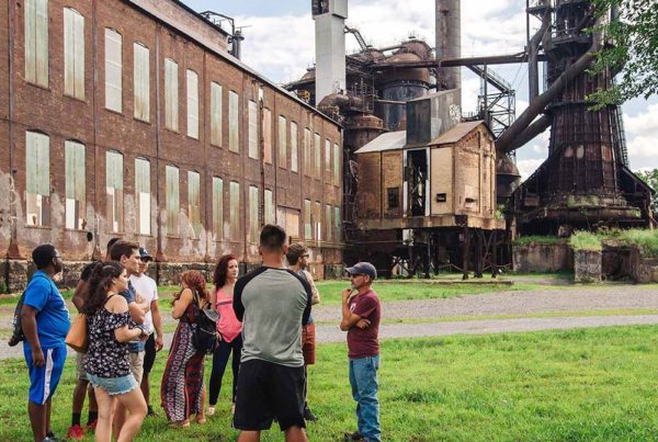A docent leading a group on the Industrial Tour at the Carrie Blast Furnaces.