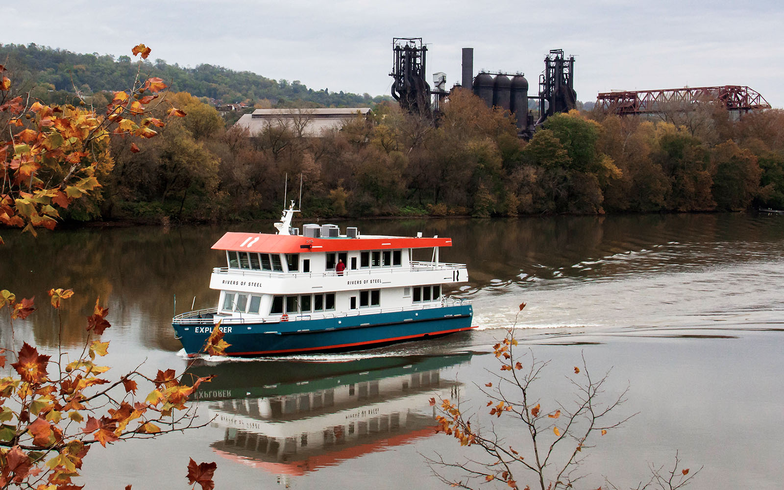 The Explorer Riverboat with the Carrie Blast Furnaces in the background. and early fall leaves.