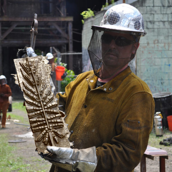 artist holding final bronze casting