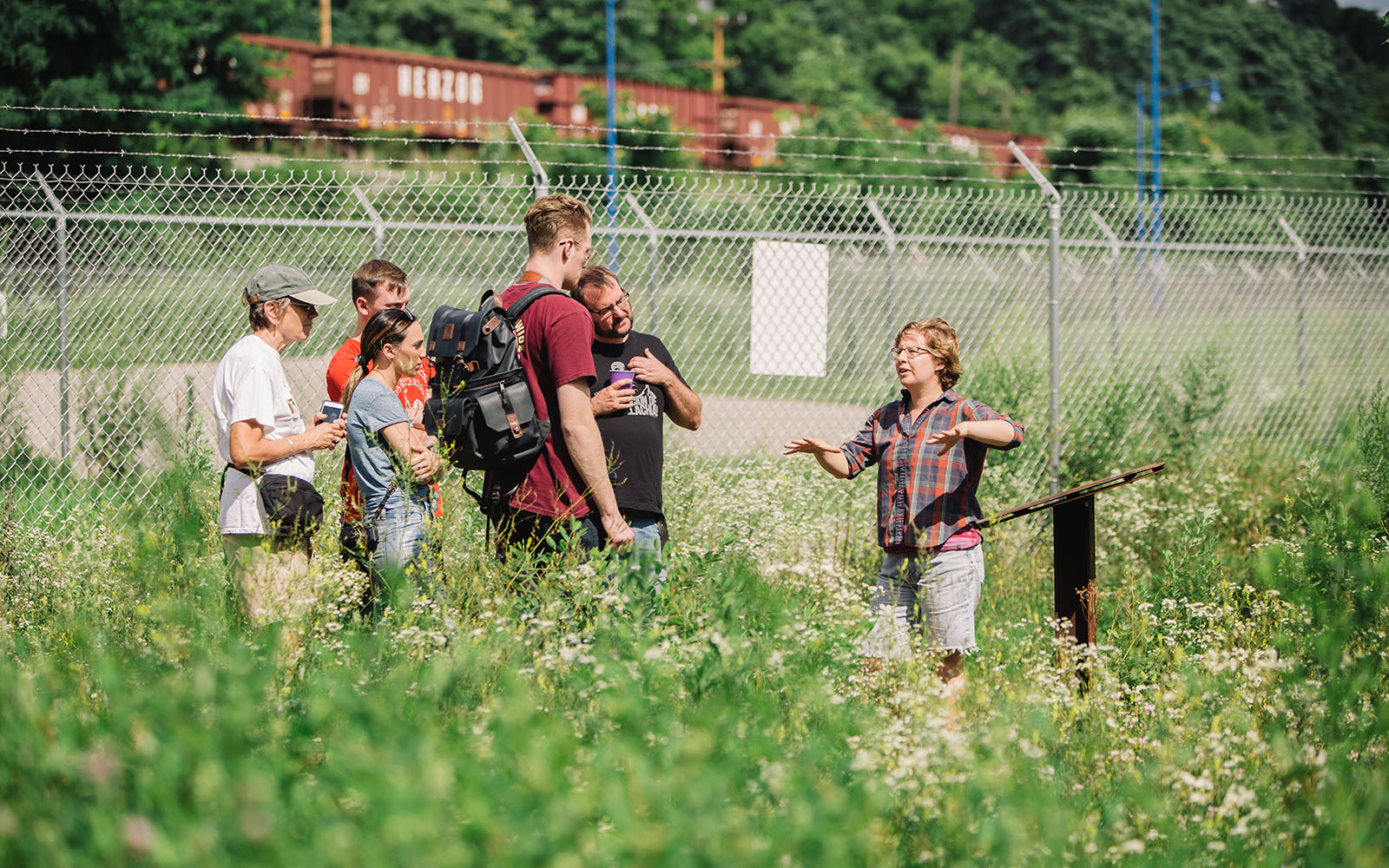 A docent leading a group on the Iron Garden Walk at Carrie Blast Furnaces.