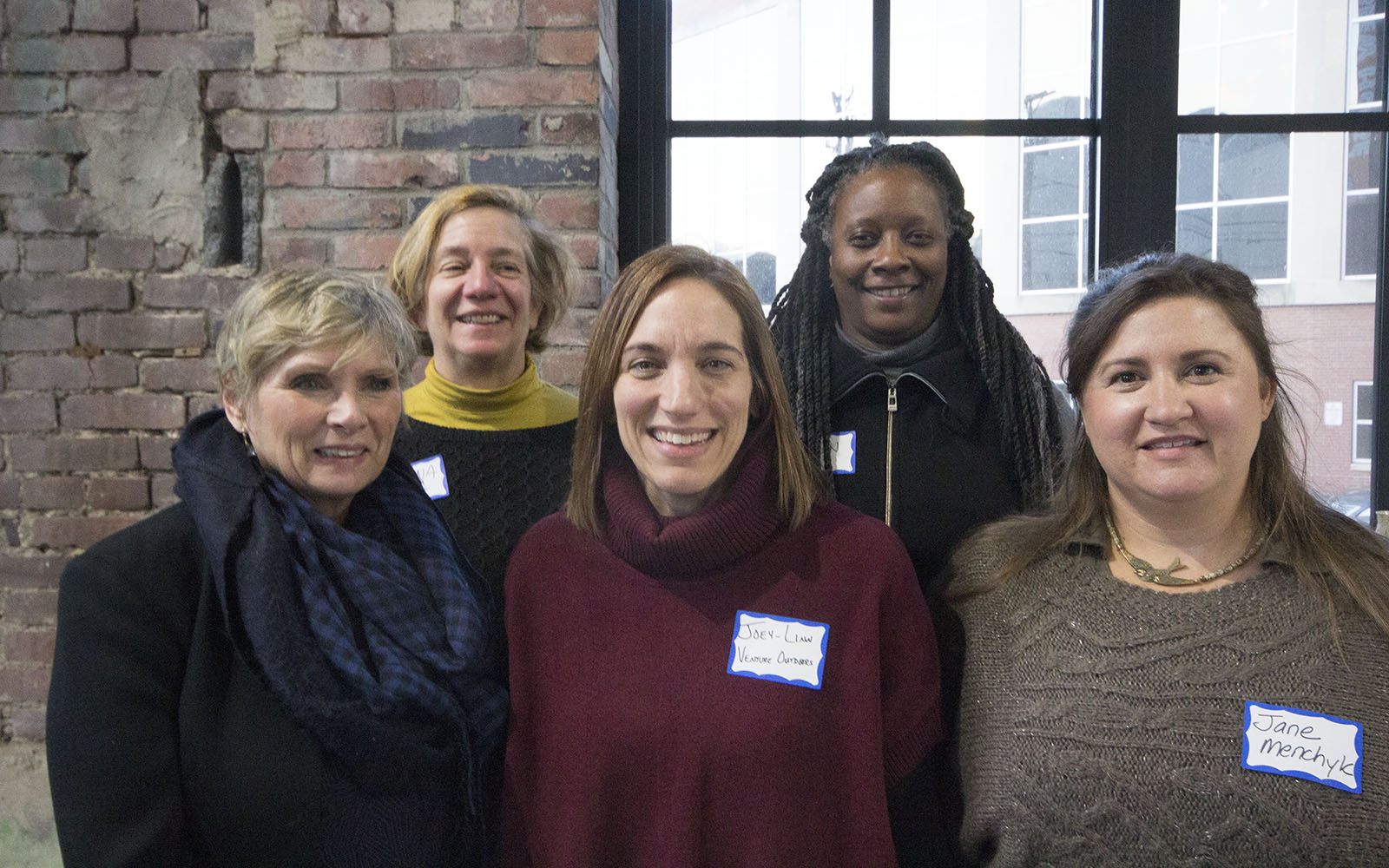 5 women post for a picture