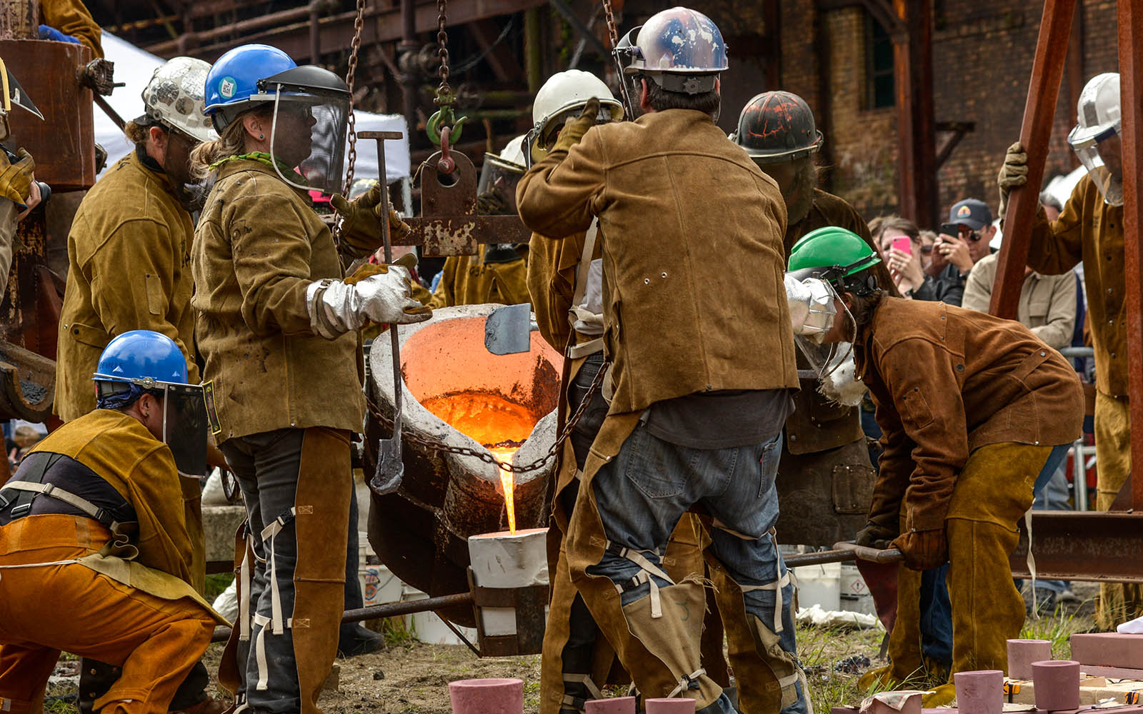 Metalworkers pouring molten metal
