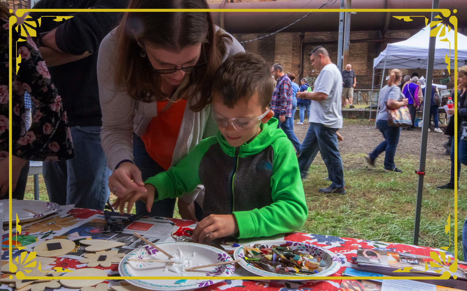 mohter and son creating glass mosaic ornament