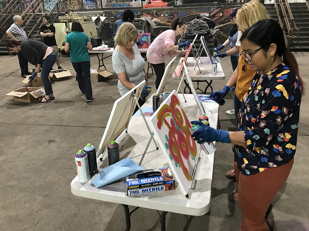 graffiti and style writing workshop participants create their paintings