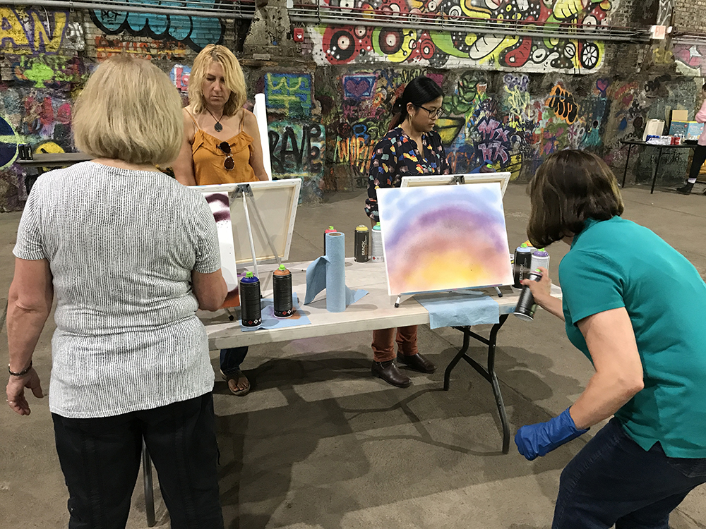 graffiti and style writing workshop participants create their paintings