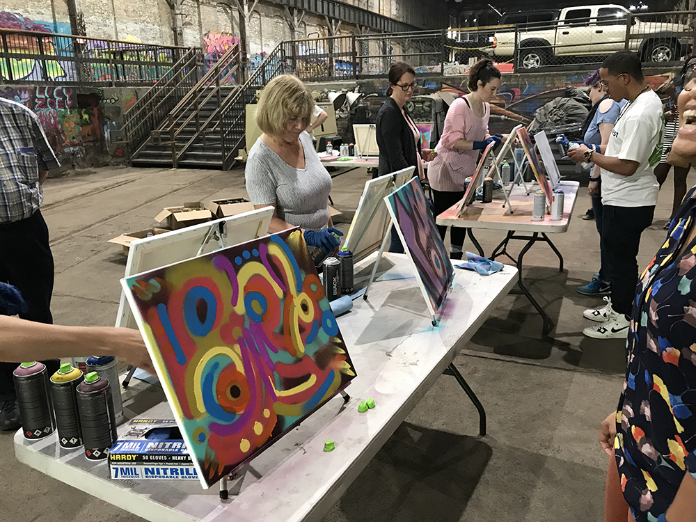 graffiti and style writing workshop participants create their paintings