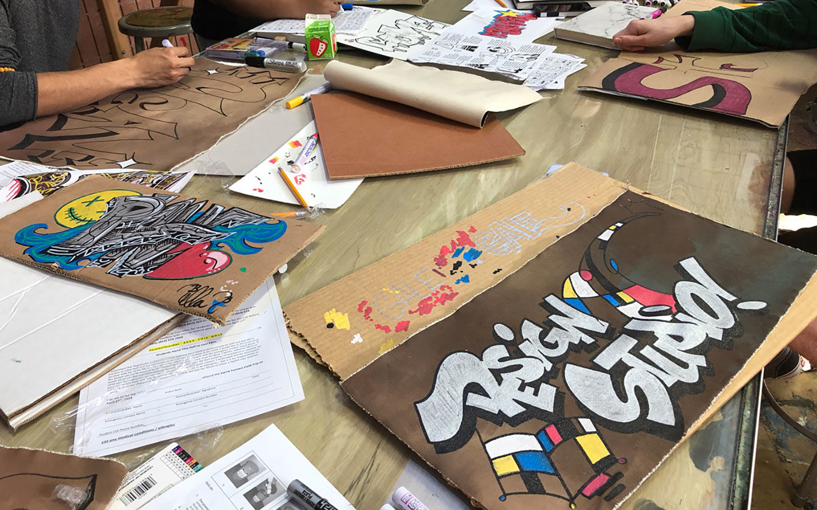students work on designs during the graffit art and style writing workshops