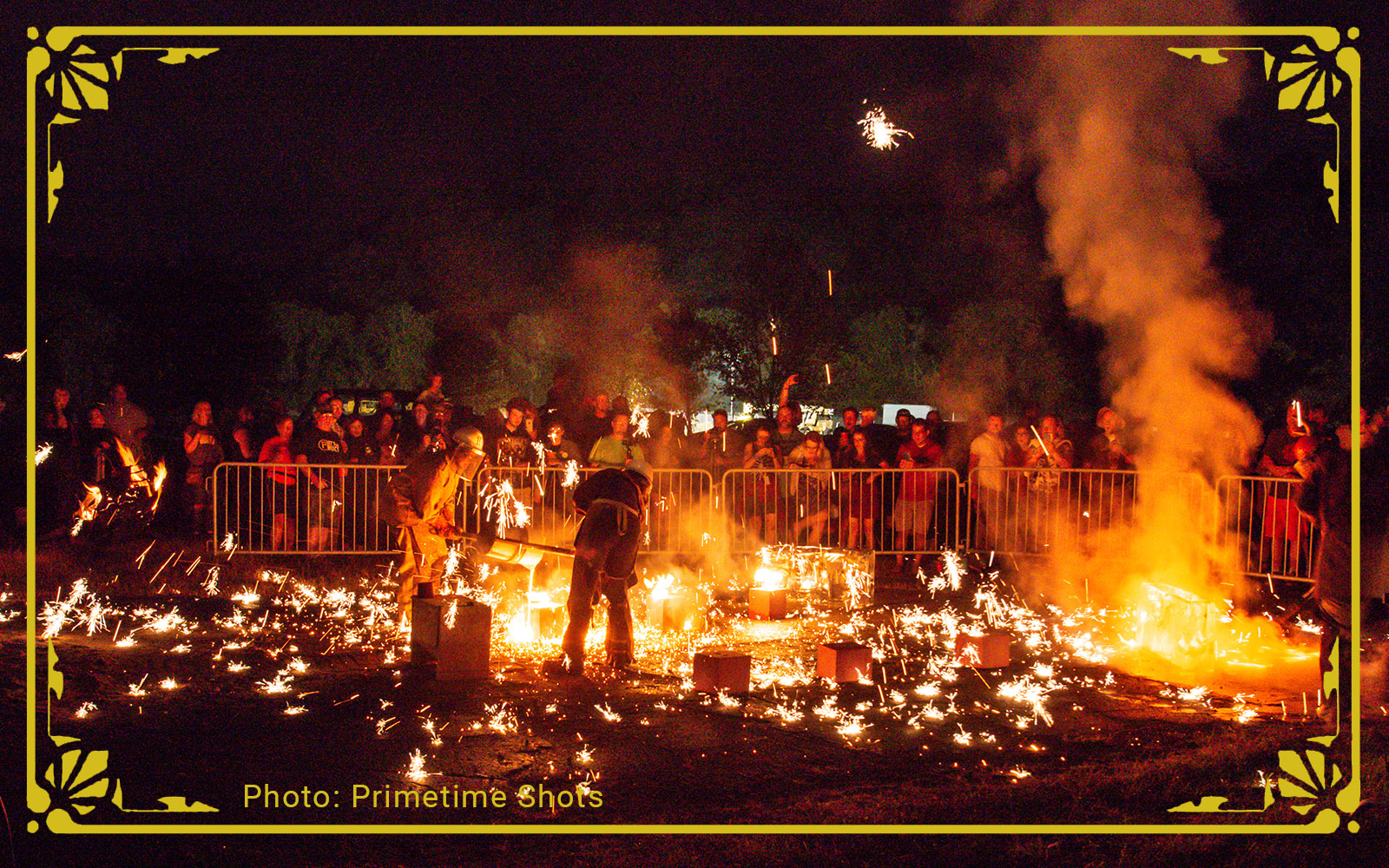 the audience watches as rivers of steel artists throw sparks during a performance iron pour