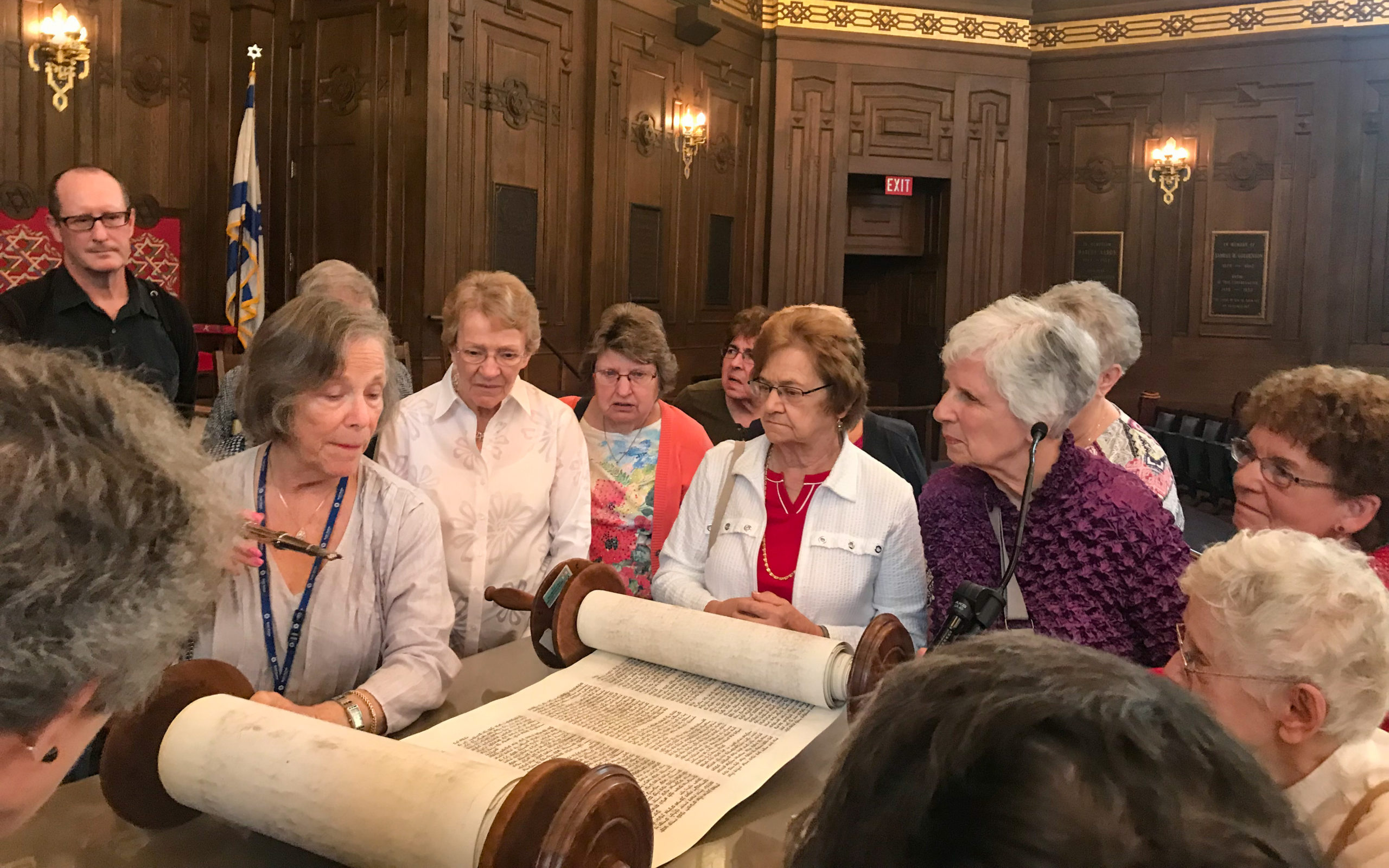 Tour group view sacred Torah at Rodef Shalom's synagogue in Oakland.