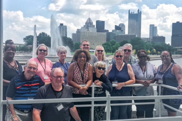 IMG-6359 tour group poses for photo with point state park in the backgroun