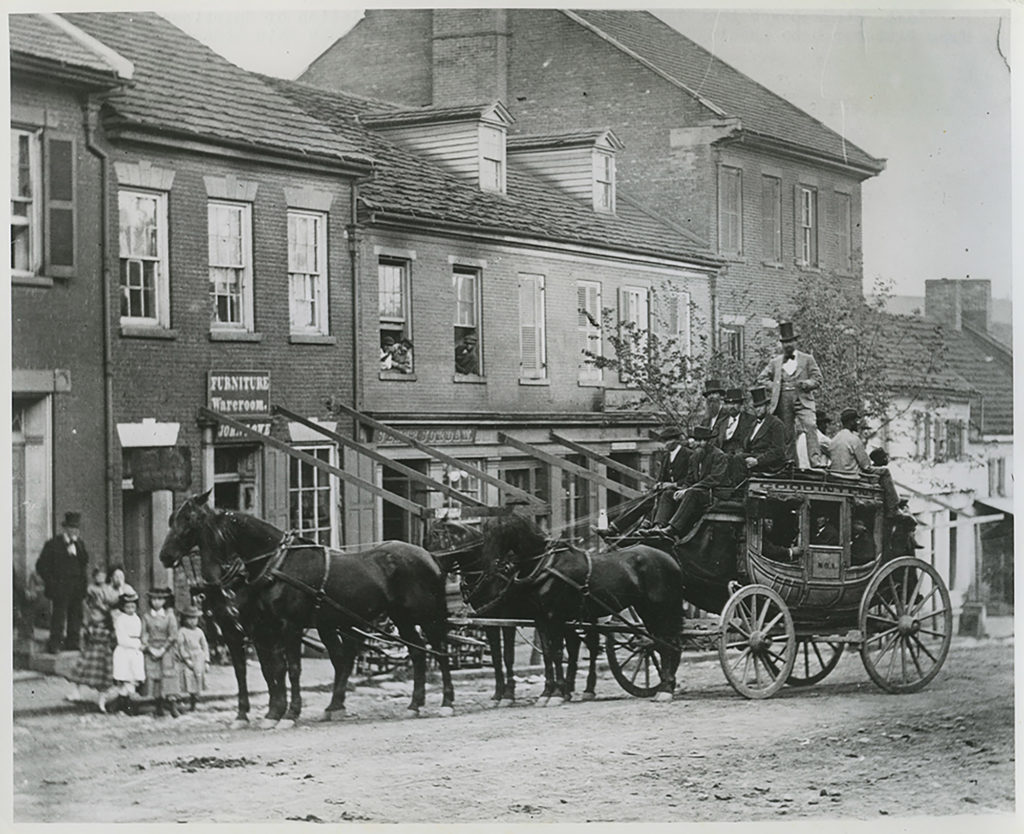 A historic image of a stagecoach rolling through a town in Washington County, Pa.