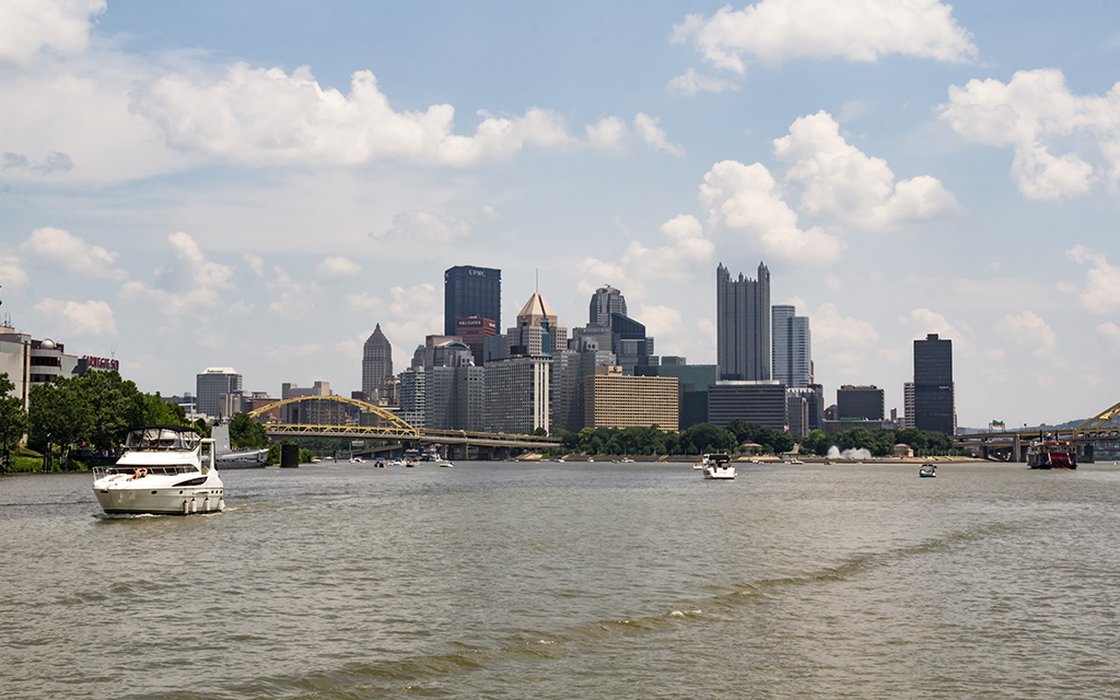 A view of downtown Pittsburgh from the water showing recreation boat traffic.