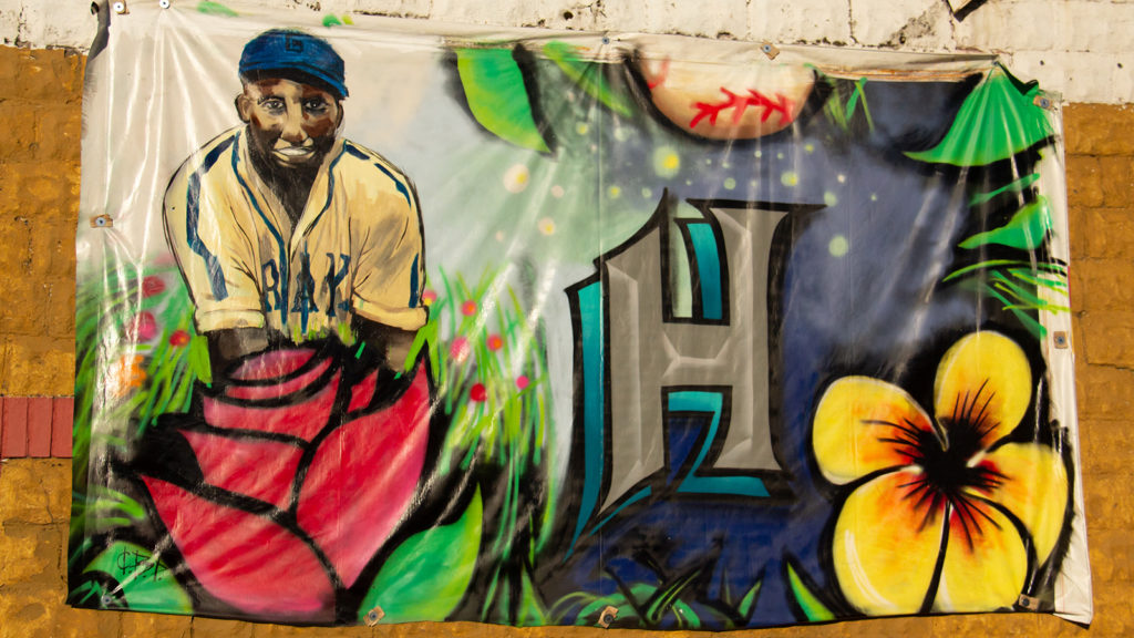 Mural with Josh Gibson, a gray "H" and flowers