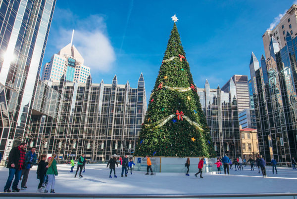 A large Christmas Tree and people ice skating