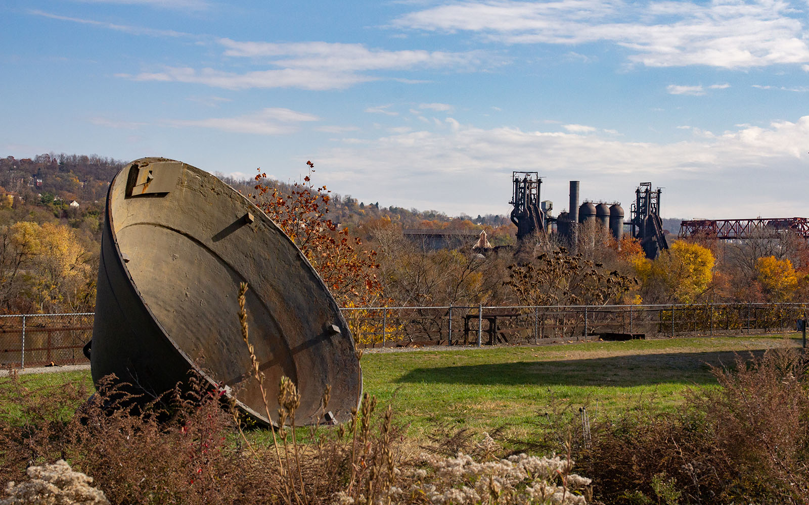 The Carrie Blast Furnaces appear across the river with an industrial furnace cap in the foreground.