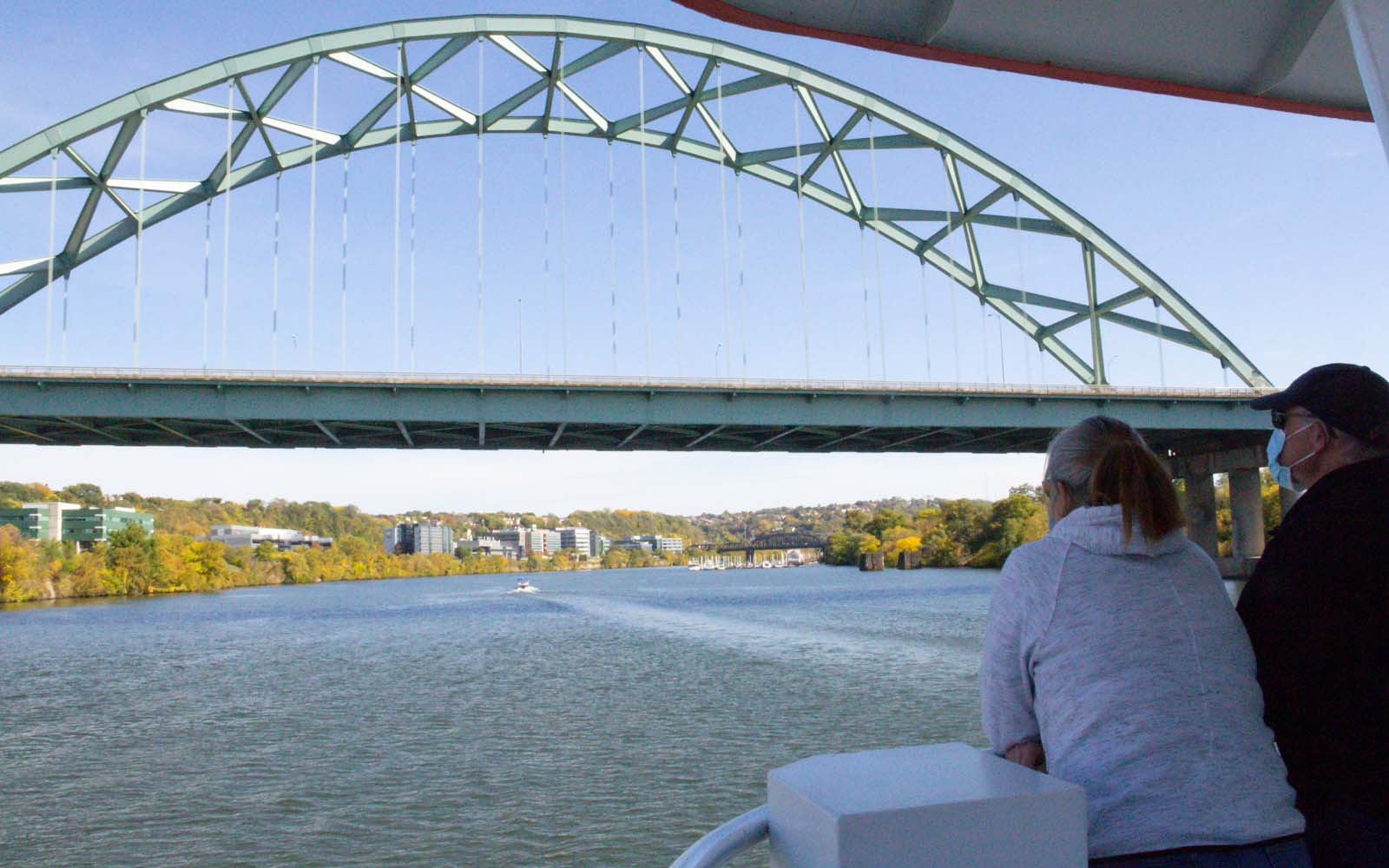 A couple look upriver at the Birmingham Bridge.