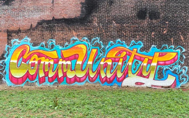 Graffiti style-writing that reads "Community"