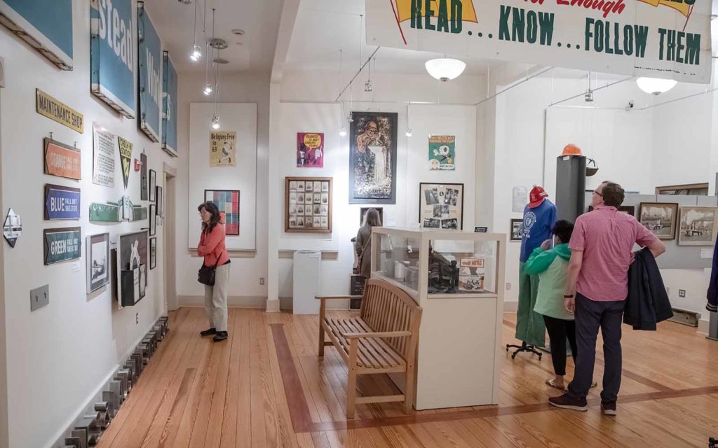 Visitors walk through exhibition galleries