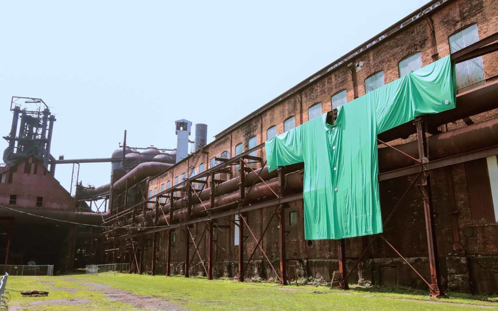 A larger than life scale "greens" jacket hangs on the wall of the blowing engine house.