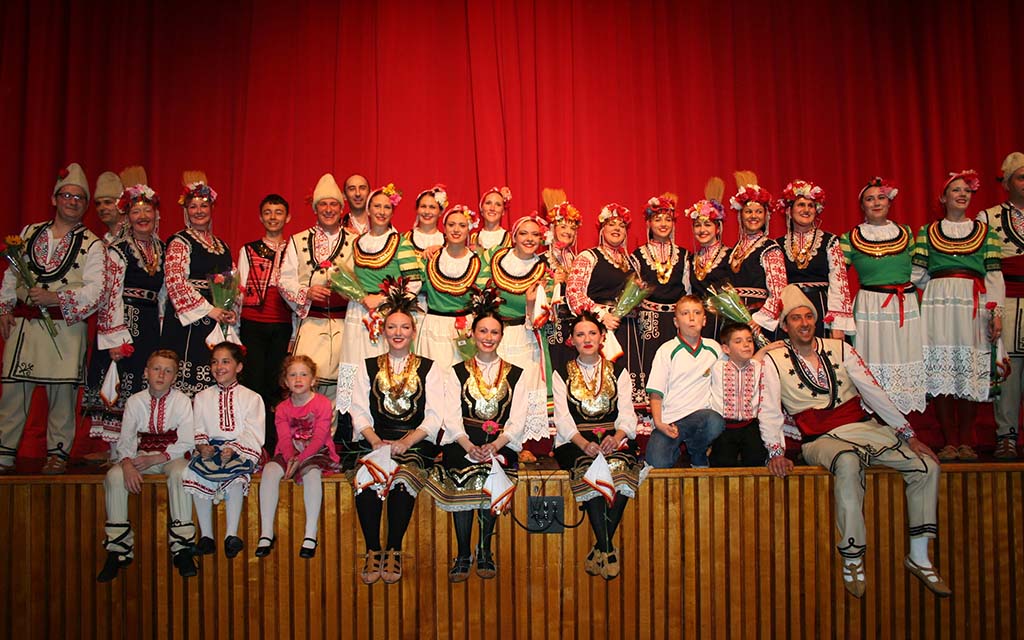 About 60 dancers pose for a group photo.