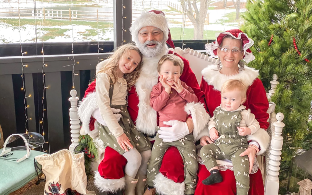 Santa & Mrs. Claus with cute kids on their lap