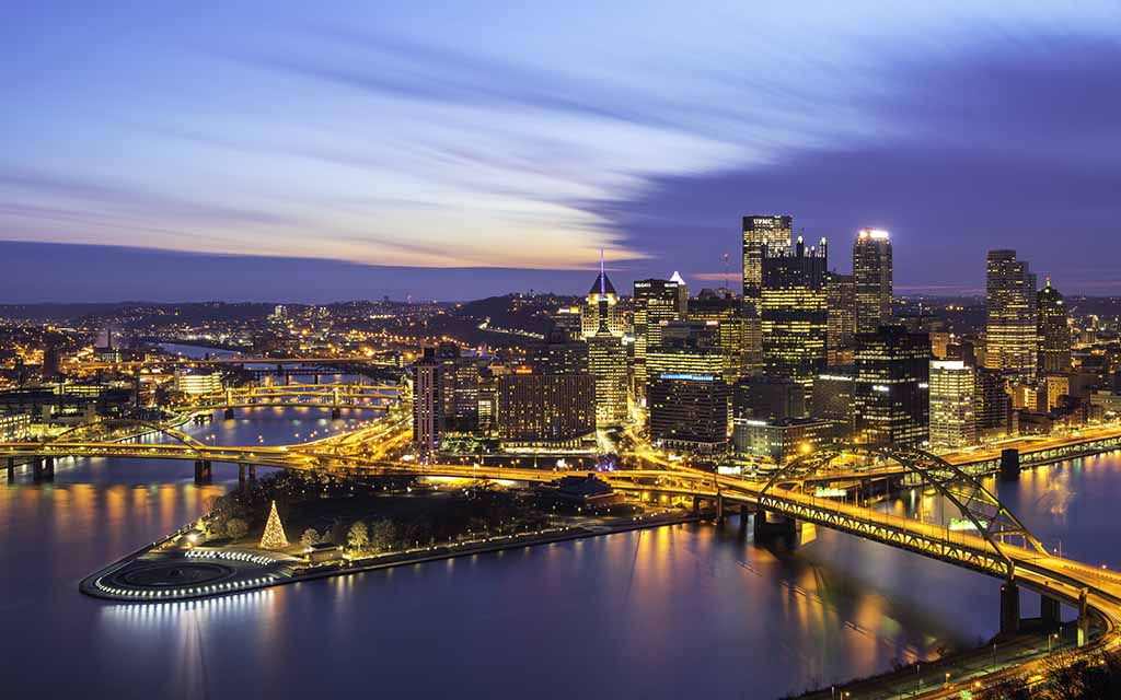 Pittsburgh's skyline at dusk with a Christmas Tree at Point State Park