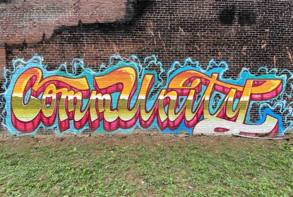 The word "Community" written in graffiti style-writing.