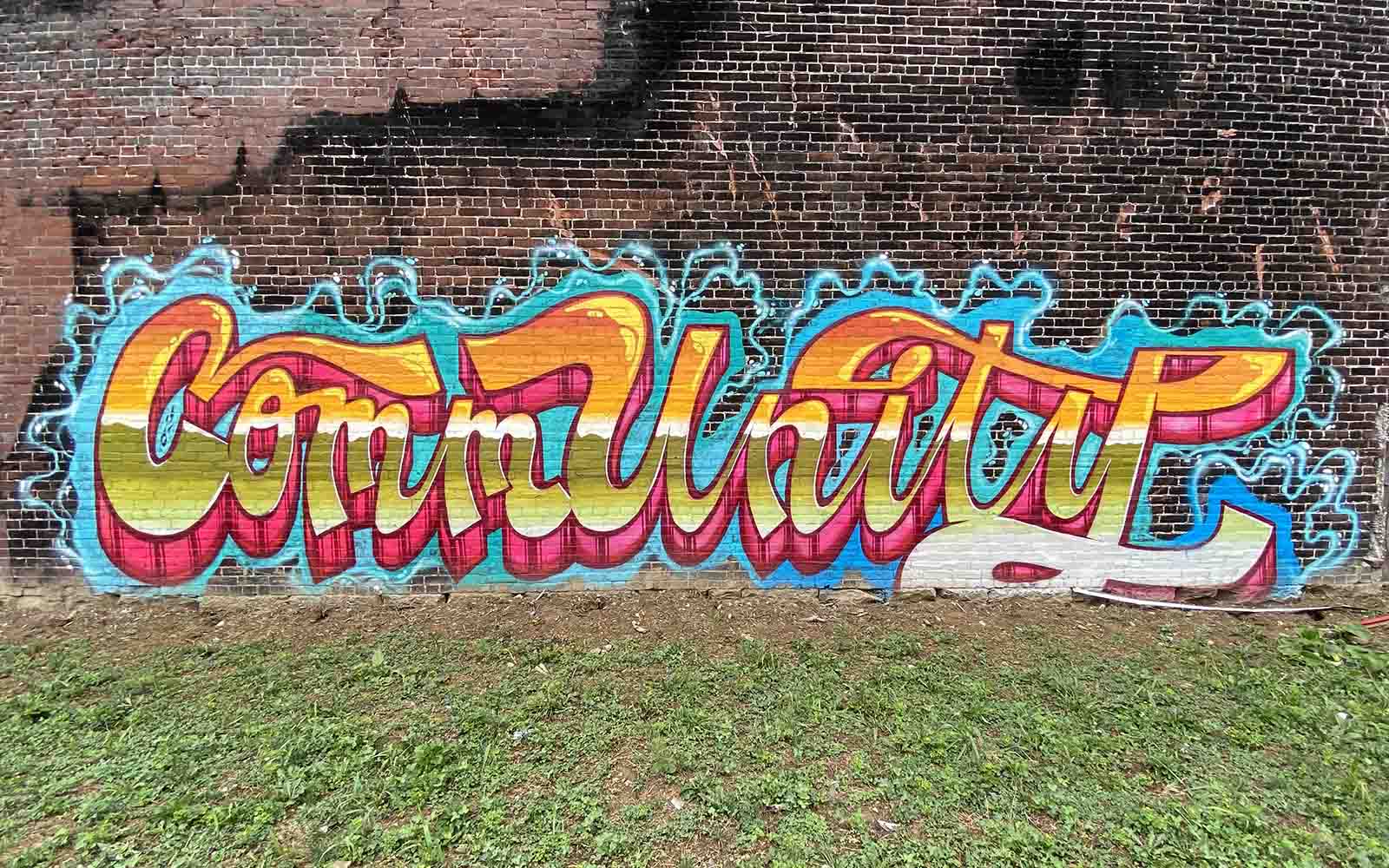 The word "Community" written in graffiti style-writing.
