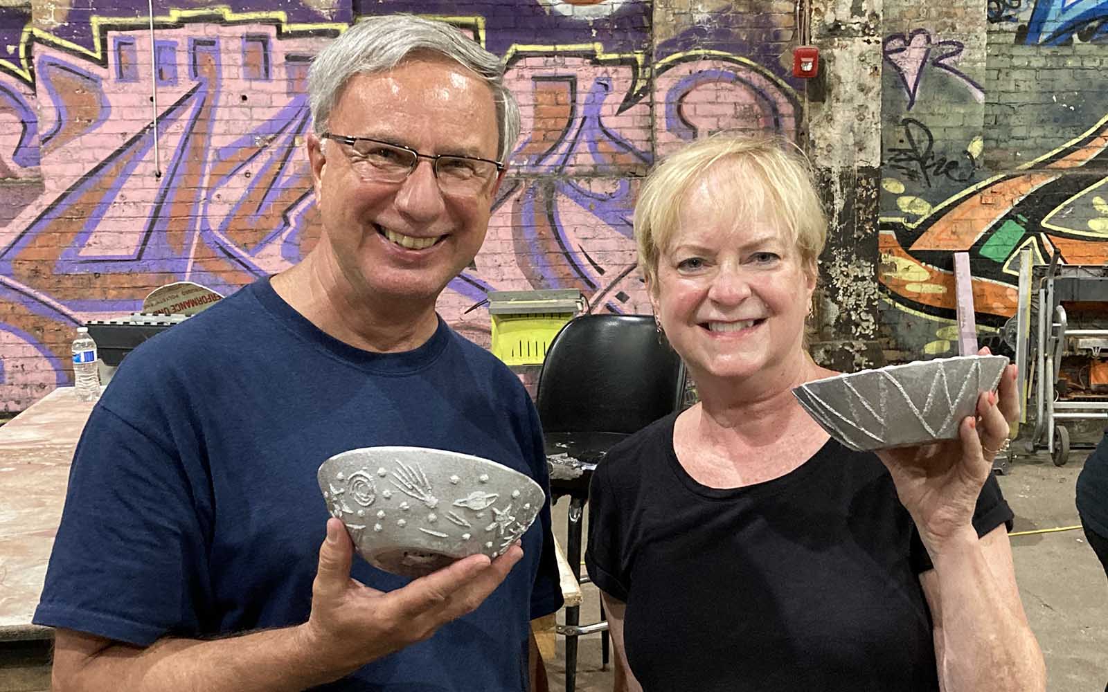 a couple display their crafted aluminum bowls
