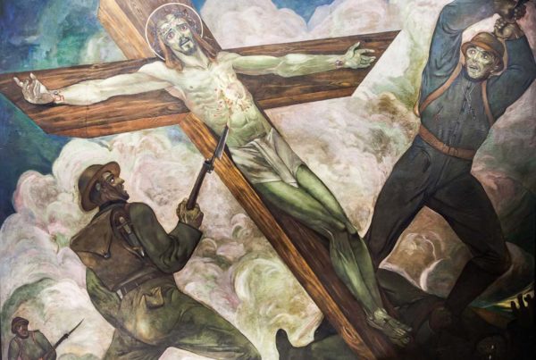 In this mural, Christ is mounted to the cross and World War I era soldiers menace him with their weapons.