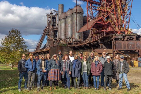 A group shot of Rivers of Steel's full time staff standing in near the ore yard at the Carrie Blast Furnaces site.