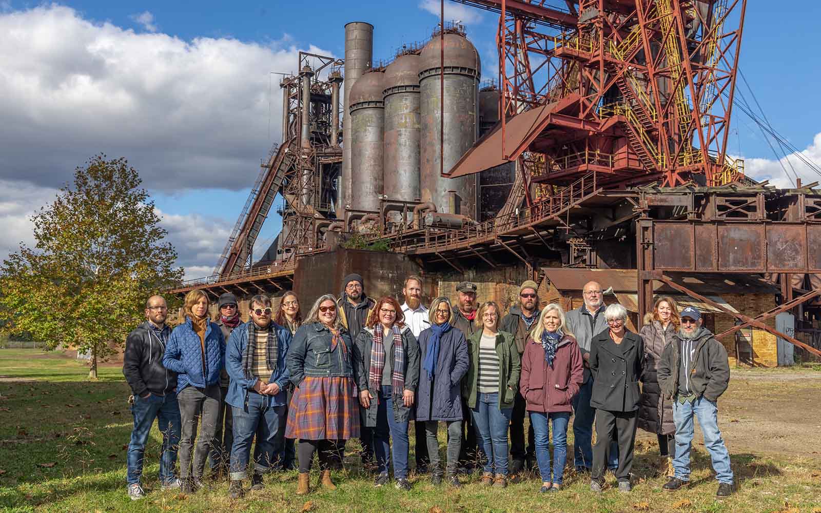 A group shot of Rivers of Steel's full time staff standing in near the ore yard at the Carrie Blast Furnaces site.