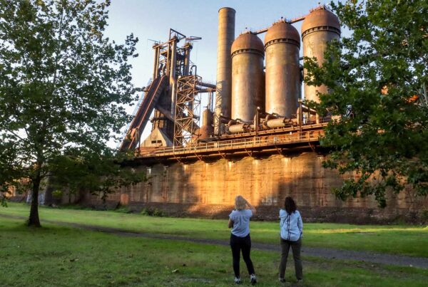 Two women look up at the Carrie Furnaces