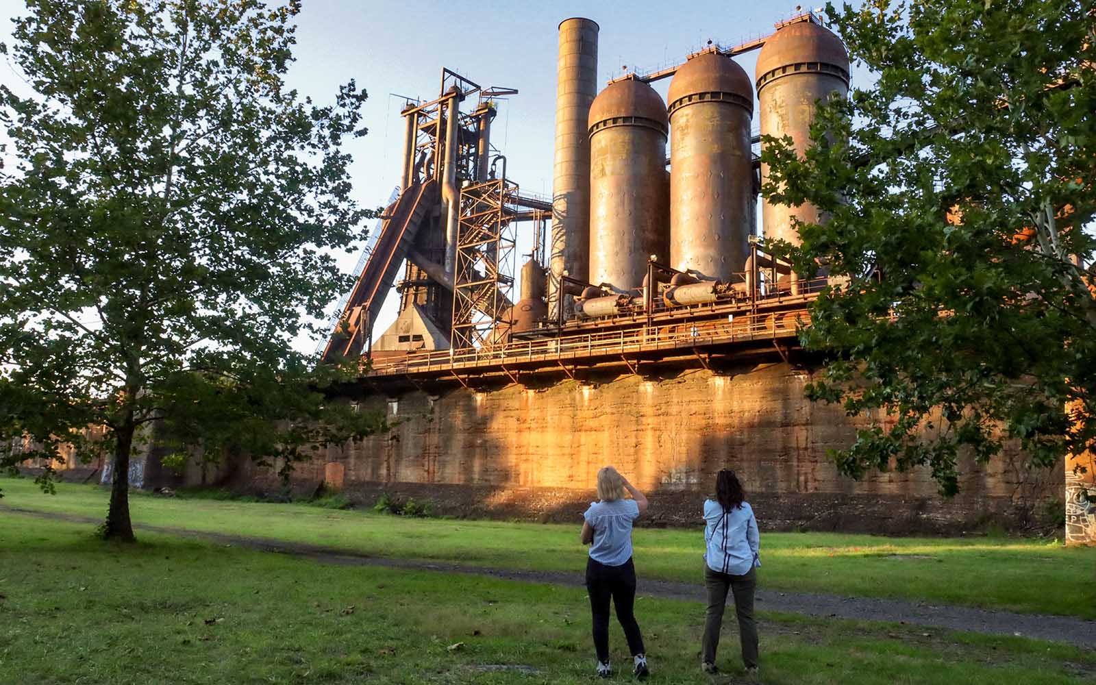 Two women look up at the Carrie Furnaces