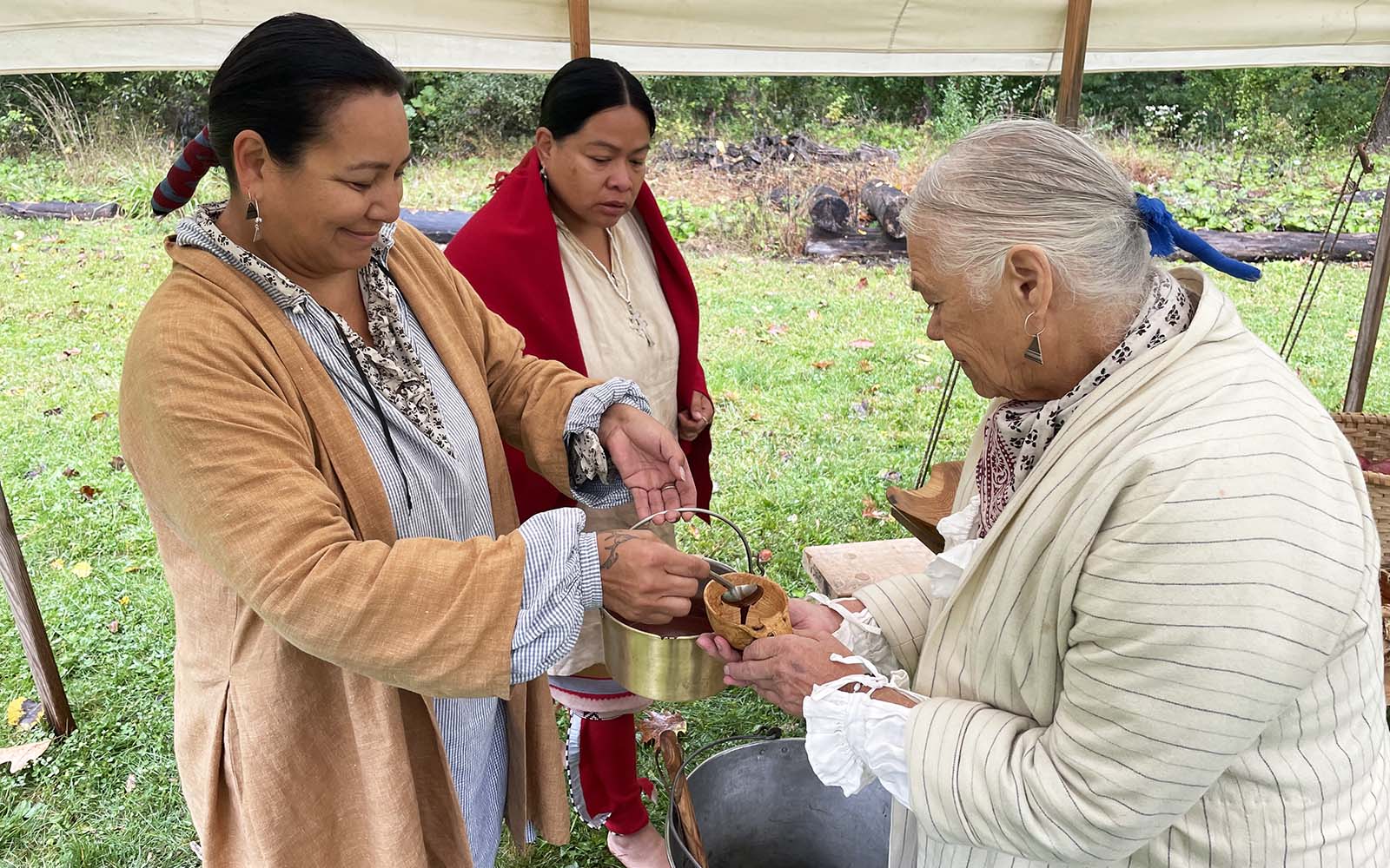 Members of local tribes share a recently brewed drink.