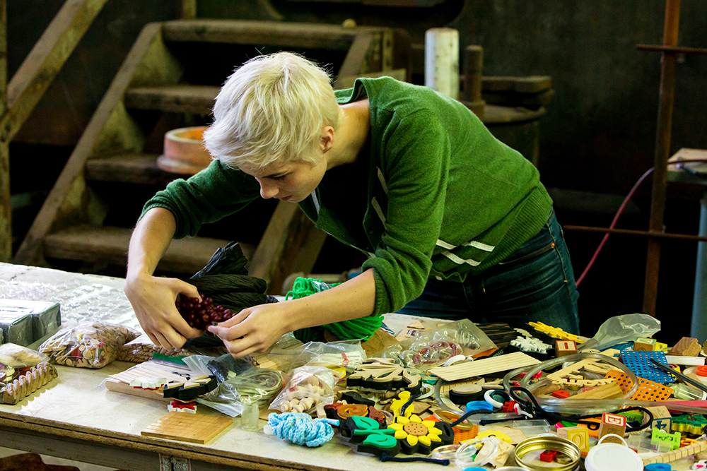 workshop participant selects materials to create her aluminum sculpture