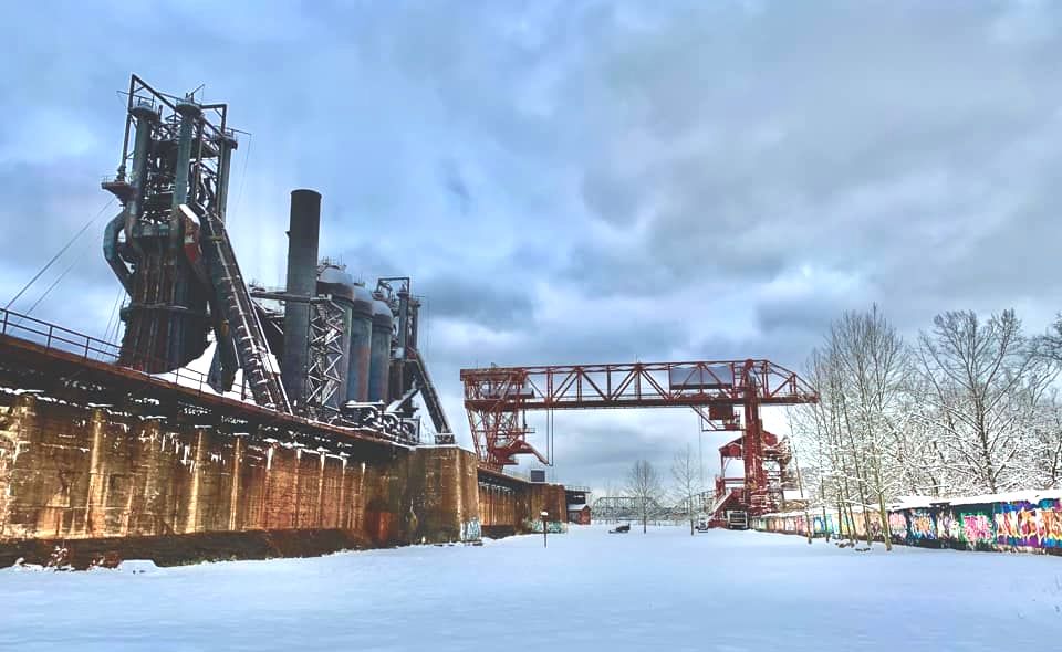 Snow blankets the ore year in fronto of the Carrie Blast Furnaces.