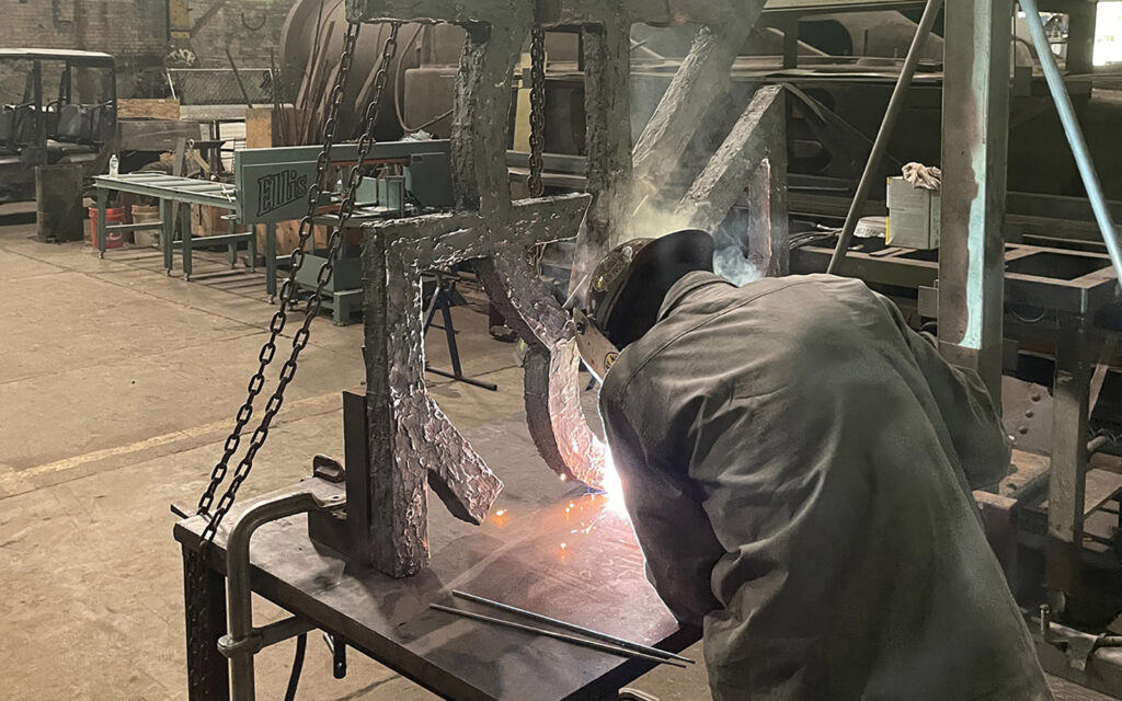 rivers off steel staff preparing artworks for installation