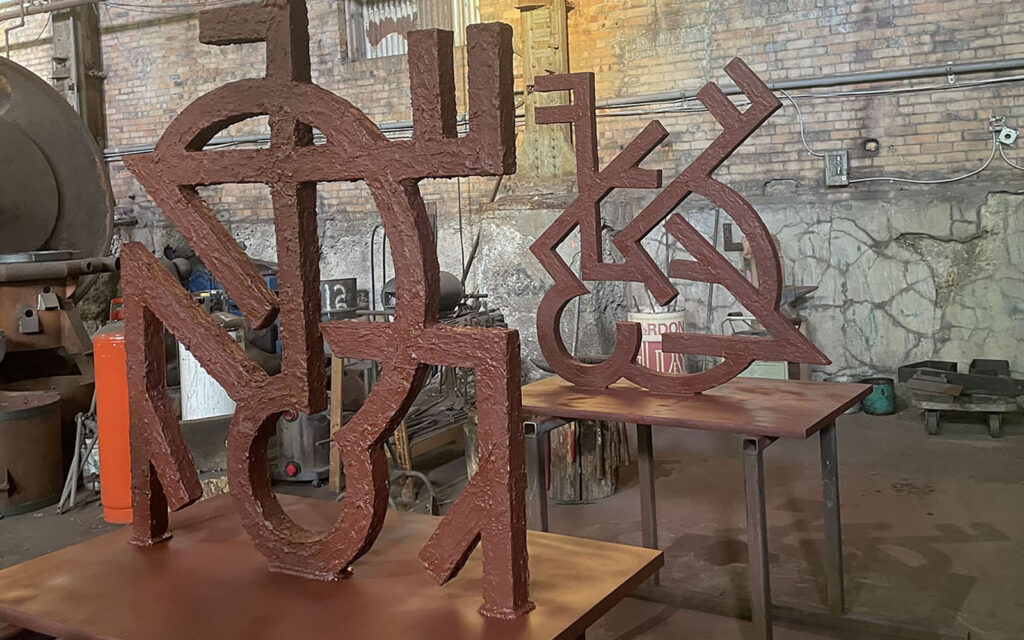 rivers off steel staff preparing artworks for installation
