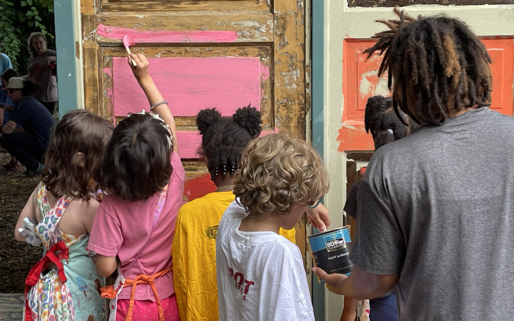 kids work on graffiti murals during Art in the Garden summer camp