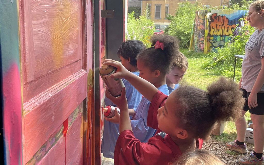 kids work on graffiti murals during Art in the Garden summer camp