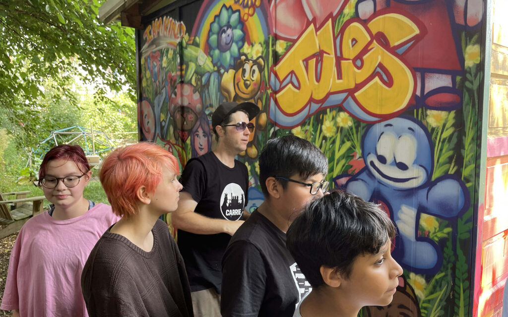 kids work on graffiti murals during Art in the Garden summer camp