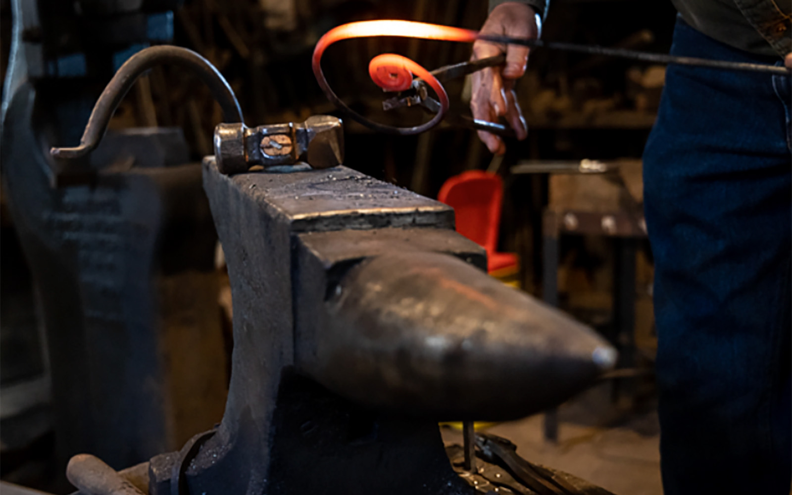close up photo of blacksmith forging an elaborate hook