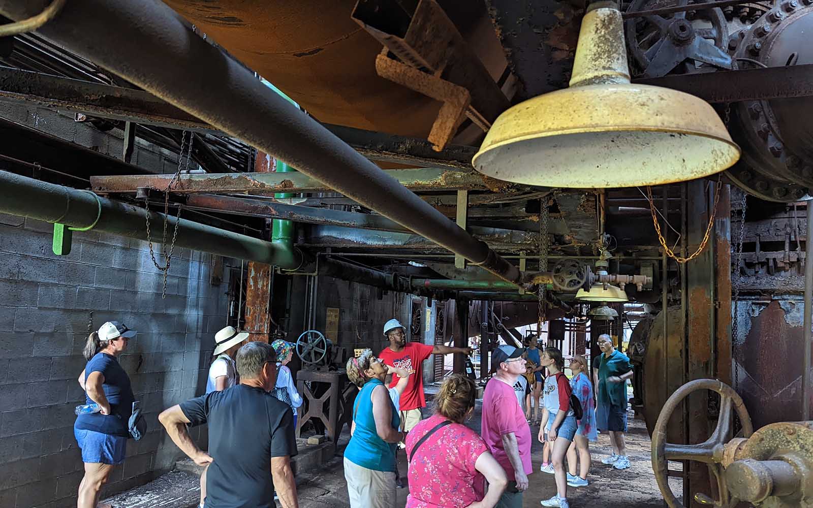 A group tours the stove deck as a guide points.