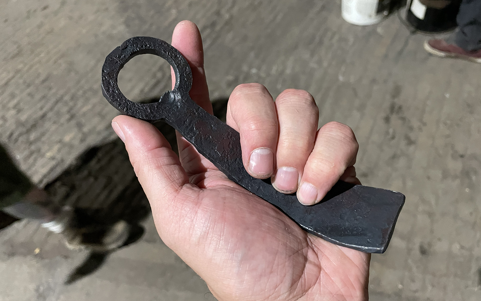 one participant displays their completed bottle opener in their hand