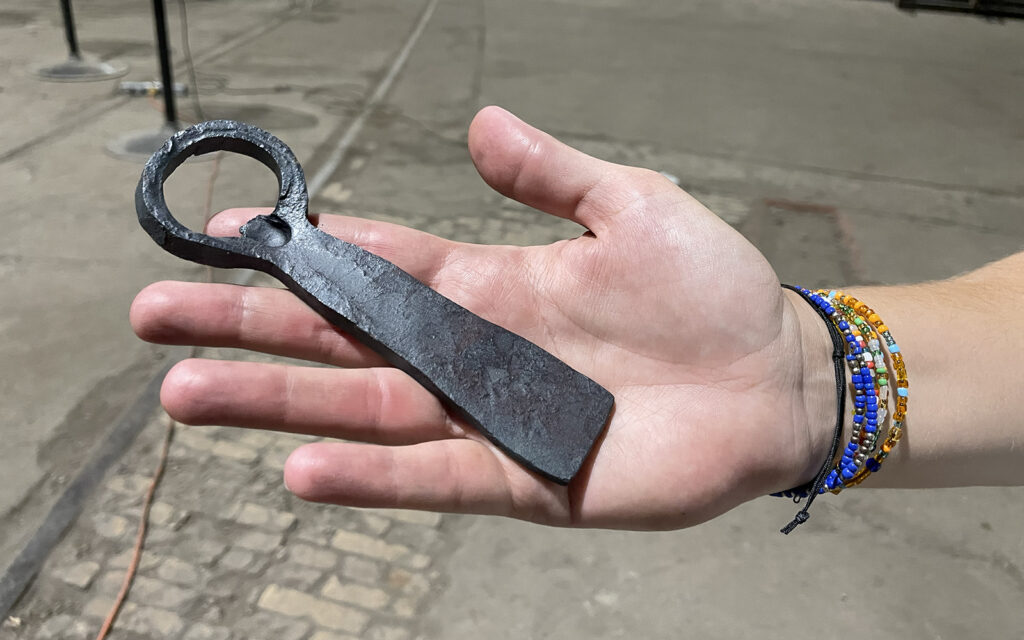 one participant displays their completed bottle opener in their hand