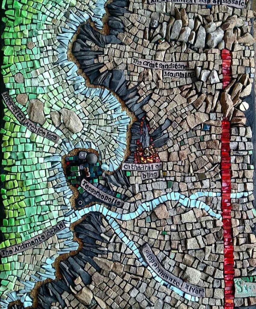 A mosaic of a landscape from above, like a map, representative of a body of water, a shoreline, some rivers and land. 