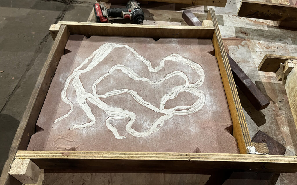 creating a sand mold from a pattern.
