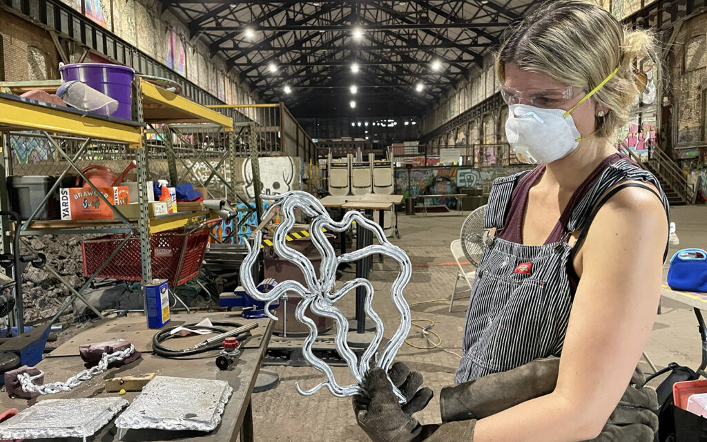 artist holding up her casting after removing it from the mold