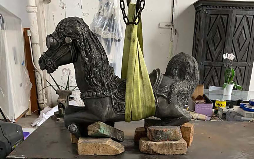 workshop participant and artist, Marsha Pells works on the surface peparation for her iron rocking horse cast during a weeklong iron intensive.